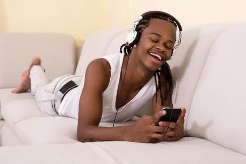 Smiling man lying and using phone Stock Photos