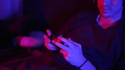 Smiling man playing video games at home with focus to his hands Stock Footage 199128671