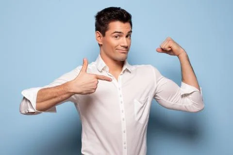 Smiling man pointing on biceps. Stock-Fotos