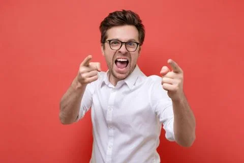 Smiling man pointing fingers at camera, picking you Stock Photos