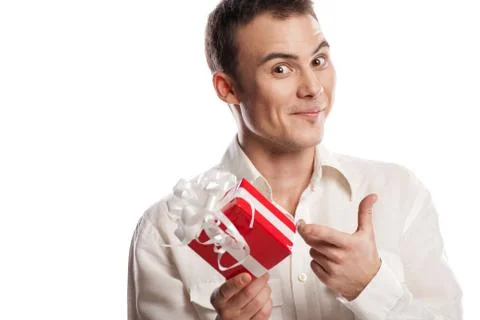 Smiling man pointing on gift isolated Stock Photos