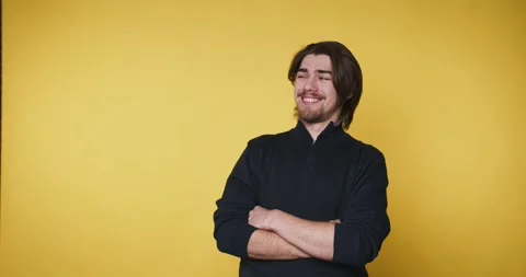 Smiling man poses in front of yellow background while showing different exp.. Vidéo 328249941