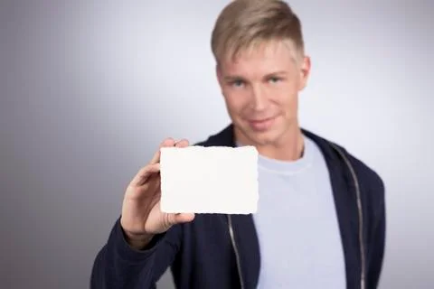 Smiling man presenting empty white card. Foto stock