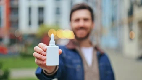 Smiling Man Presents Nasal Spray for Wellness and Relief Stock Footage 320474091