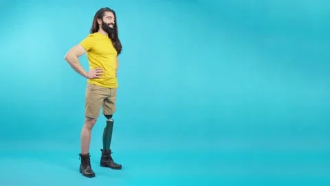 Smiling man with prosthetic leg looking to the copy space aside 動画素材 228801504