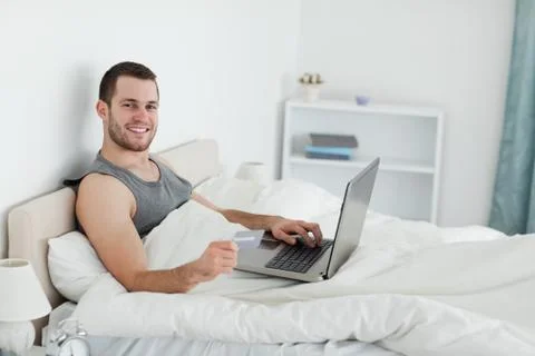Smiling man purchasing online Stock Photos