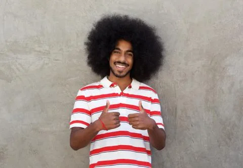 Smiling man standing with both thumbs up Stock Photos