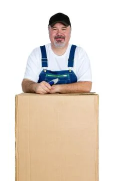 Smiling man standing over large cardboard box Stock Photos