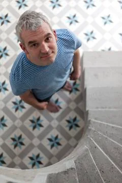 A smiling man standing on a pattern floor Stock Photos