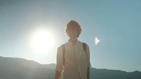 Smiling man strolls along beach on summer morning. Video stock 77456696