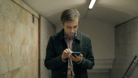 Smiling man subway underground walking in front of the train talking with the Stock Footage 89095900
