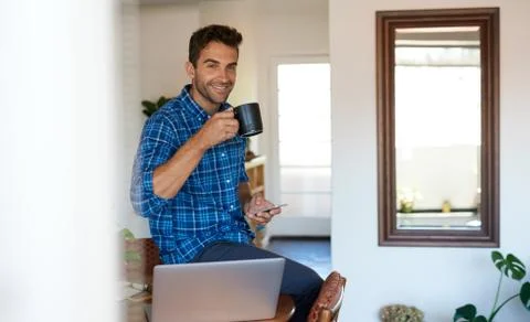 Smiling man taking a break from working remotely at home Stock Photos