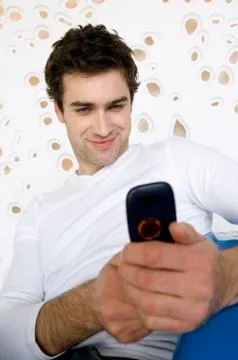 Smiling man taking picture with camera phone Stock Photos