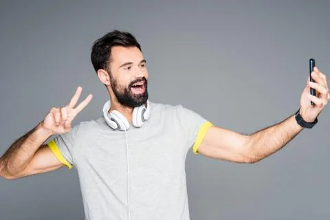 Smiling man taking selfie Stock Photos