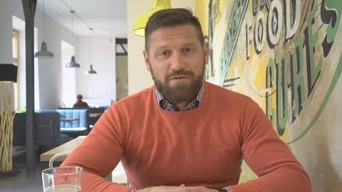 Smiling man talking at camera, portrait, in pub, cafe, indoor, steadicam Vídeo Stock 73230186