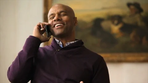 Smiling man talking on cellphone. 스톡 동영상 88405956