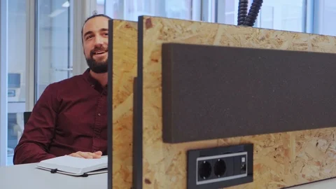 Smiling man talking on the mobile phone in the office Stock Footage 101744432
