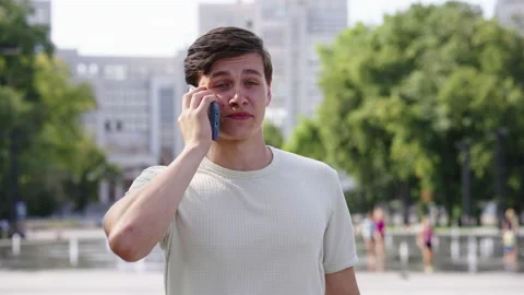 Smiling man talking on phone while walking in city Stock Footage 158922048