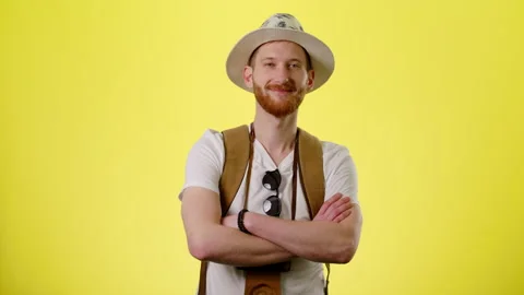 Smiling Man With Tourist Backpack, Hat And Camera Standing And Looking At Camera Stock Footage 170185804