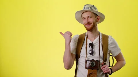 Smiling Man With Tourist Backpack, Hat And Camera Pointing On Copyspace Stock Footage 170186745