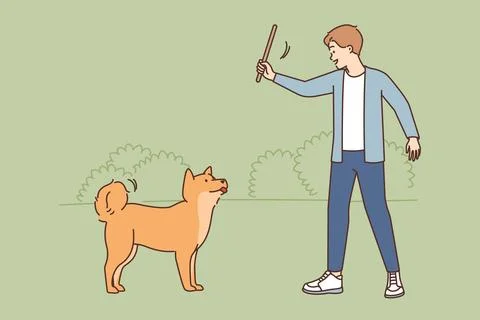 Smiling man training with dog in park Ilustración de archivo