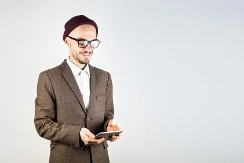 Smiling man in tweed jacket with a tablet computer. Stock Photos