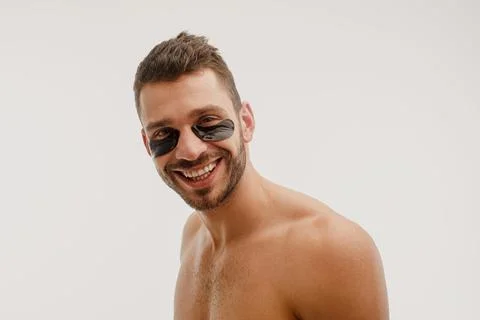 Smiling man with under eye patch on face Stock Photos