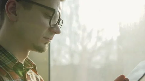 Smiling man using digital tablet in a glass elevator - slow motion 库存影片 62503408