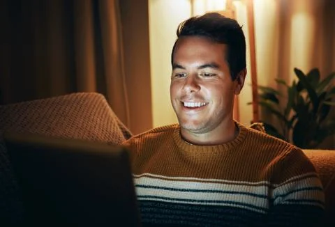 Smiling man using digital tablet at home late at night Stock Photos