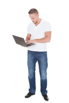 Smiling man using a handheld laptop computer Stock Photos