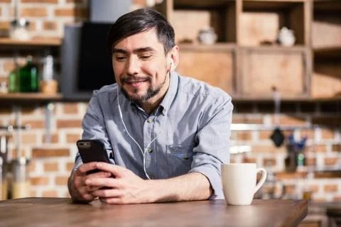 Smiling man using his smartphone Stock Photos