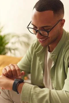 Smiling Man Using Smart Watch. Multiracial Guy Touching Wrist Watch Stock Photos