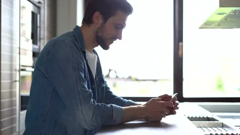 Smiling man using smartphone. Handsome person spending leisure time with gadget Stock Footage 155331289