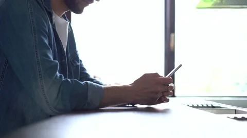 Smiling man using smartphone. Handsome person spending leisure time with gadget Stock Footage 155331290