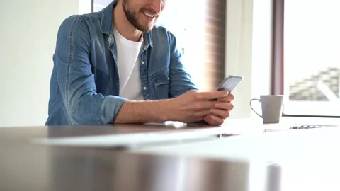 Smiling man using smartphone, spending leisure time at home with modern gadget Stock Footage 155332355
