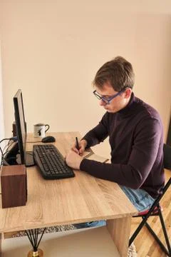 Smiling man working on computer at desk in office 写真素材