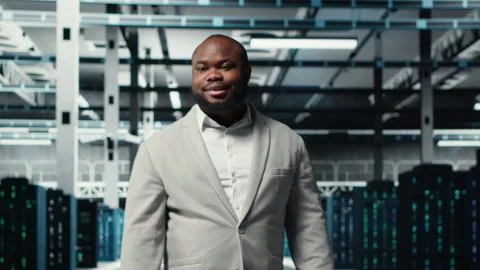 Smiling manager in data center doing checkup on hardware to avoid downtime Stock Footage 311960092