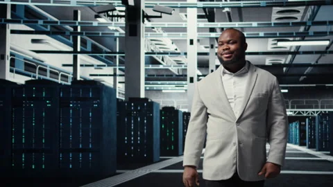 Smiling manager in data center doing checkup on hardware to avoid downtime Stock Footage 311961745