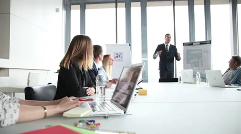 Smiling manager giving presentation to colleagues Stock Footage 59544606