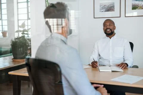Smiling manager interviewing a potential employee in his office Stock Photos