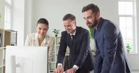 Smiling managers teamwork at desktop computer discussing strategy in office Stock Footage 335880738