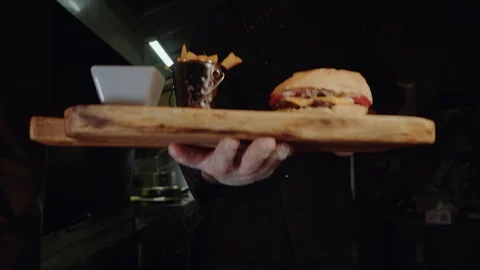 Smiling master chef in uniform looking at camera, holding plate with served Stock Footage 97602018