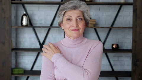 Smiling Mature gray haired middle aged woman looks at the camera, a happy old Stock Footage 137587159