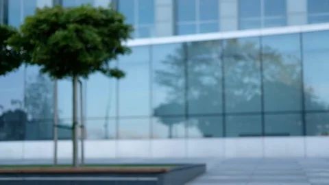 Smiling mature man sits with tablet against office building Stock Footage 115884701