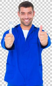 Smiling mechanic holding spanner while gesturing thumbs up Stock Photos