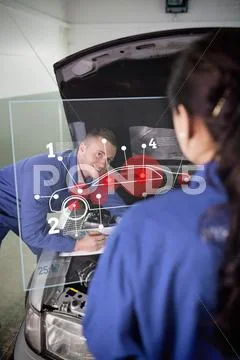Smiling mechanic looking up at colleague with a futuristic interface Stock Photos