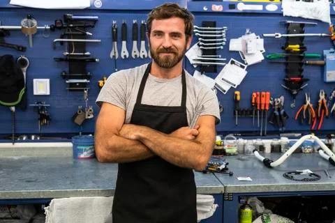 Smiling mechanic standing in workshop Stock Photos