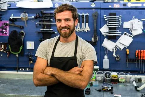 Smiling mechanic standing in workshop Stock Photos
