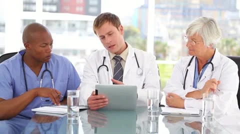Smiling medical team using a tablet pc together Stock Footage 10865934