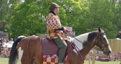 Smiling Medieval Rider on a Horse in Red and Yellow Checkered Barding Stock Footage 340264777